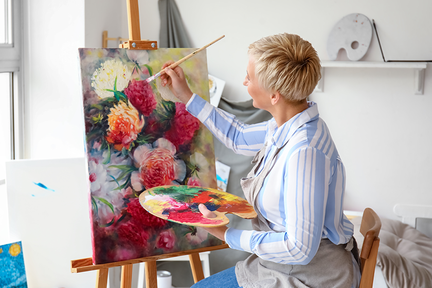 Mature female artist painting