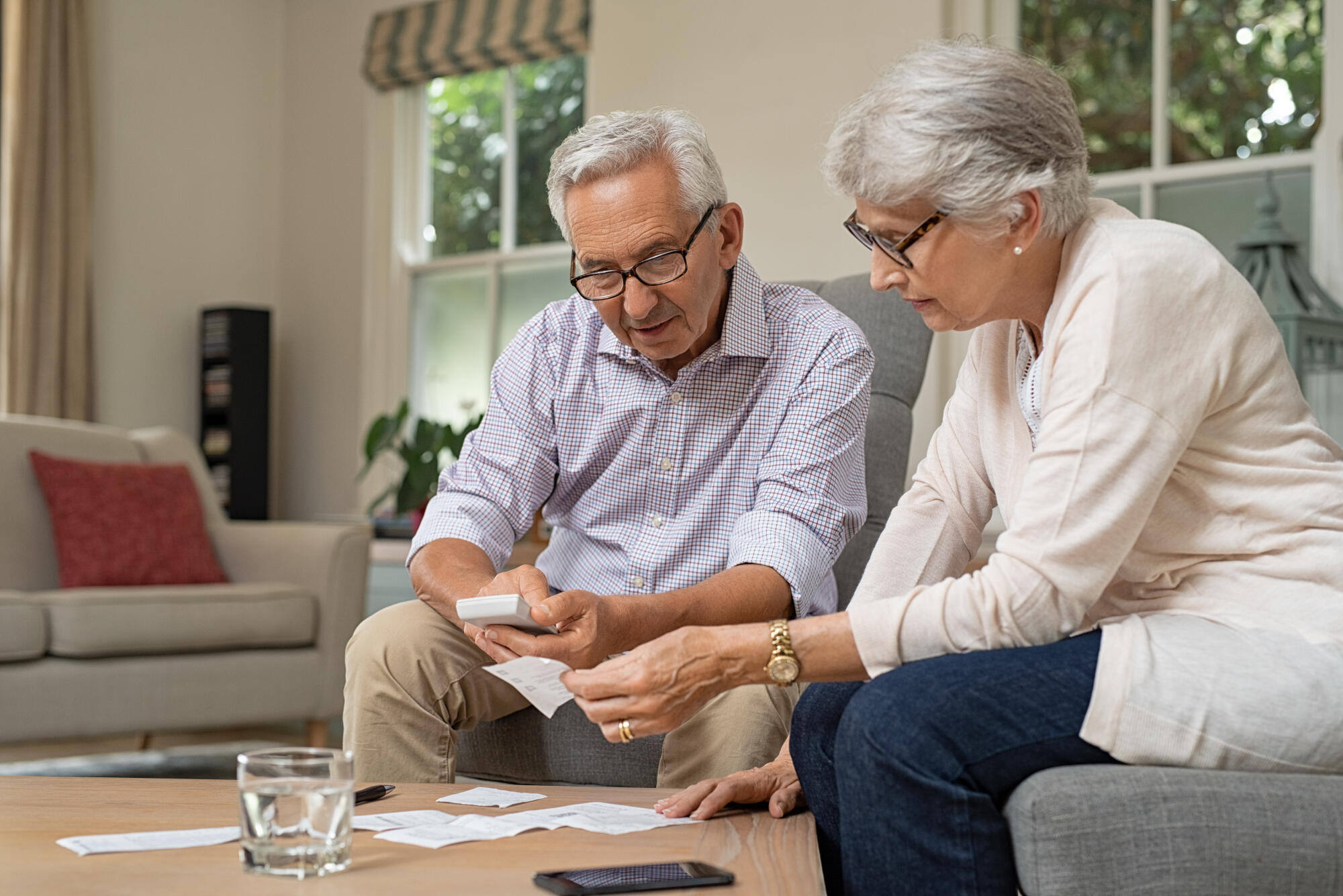 Senior couple calculating bills