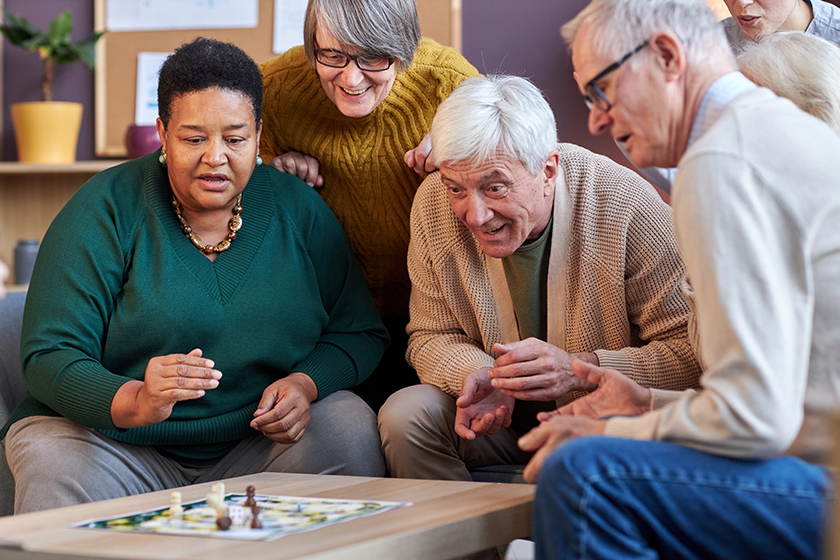 Group of senior people playing board games together